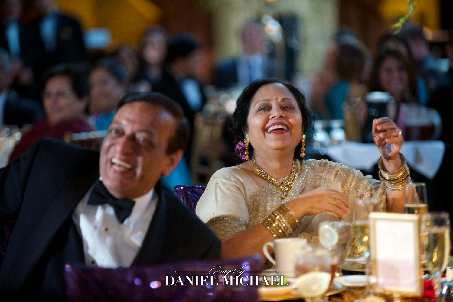 South Asian wedding photographer capturing a candid moment of parents at a reception